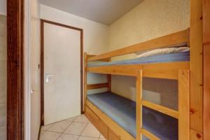 a bunk bed room with two bunk beds and a door at Studio with balcony in the center of the village in Le Grand-Bornand