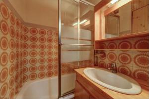 a bathroom with a tub and a sink and a shower at Studio with balcony in the center of the village in Le Grand-Bornand