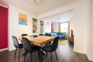 a dining room with a wooden table and chairs at Vibrant Spring Street with Garden in Brighton & Hove