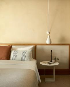 a bedroom with a bed and a side table at PAROCKS Luxury Hotel & Spa in Ambelas