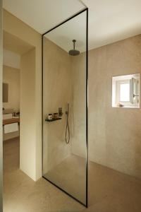 a shower with a glass door in a bathroom at PAROCKS Luxury Hotel & Spa in Ambelas
