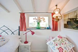 a bedroom with a bed and a window at The Studio Cottage, with, Sea views, Garden, Amazing Location by beach in Sennen