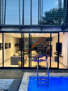 a house with a swimming pool and a bedroom at Ten On Lane in Polokwane