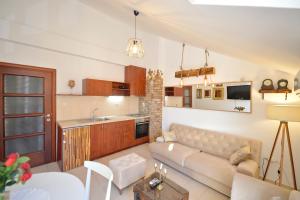 a living room with a couch and a kitchen at Stylish apartment 22 in Kotor