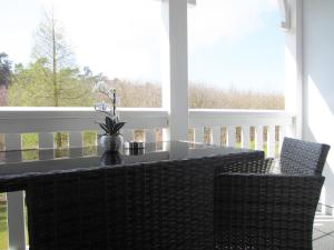 a screened porch with a table and two chairs at Ferienwohnung Waldblick Nr. 17 in Kühlungsborn