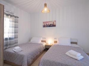a bedroom with two beds with towels on them at Marilena Luxury Sea View Private Villa in Gouves +34 photos