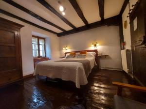 a bedroom with a large bed in a room at CASA RURAL Urruska in Elizondo