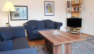 a living room with a couch and a table and a tv at Ferienwohnung Soldo in Kühlungsborn