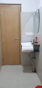 a bathroom with a sink and a mirror next to a door at Shree R.C.VATIKA in Motīhāri