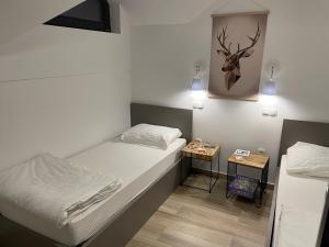 a small room with a bed and a side table at Apartma Lilija Golte in Mozirje