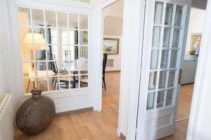 a room with white walls and a doorway with glass doors at Orquideas in Cala Galdana
