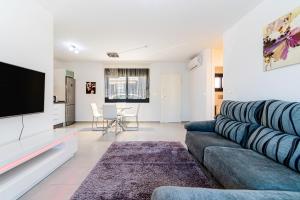 TV a/nebo společenská místnost v ubytování Apartamento Peonia
