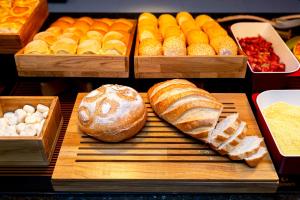 a display of different types of bread and pastries at Nacional Inn Rondonópolis in Rondonópolis