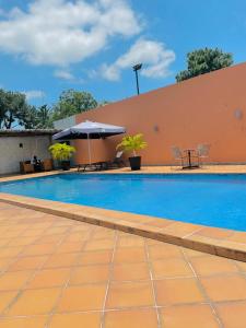 - une piscine avec une table et un parasol dans l'établissement class hotel, à Brazzaville