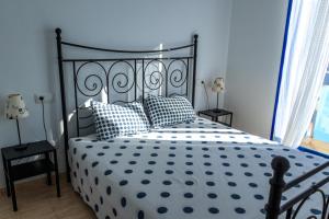 a bedroom with a black and white bed with pillows at Mar del Delta in L'Ampolla +38 photos