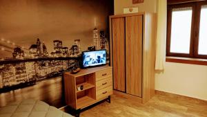 a bedroom with a tv on a dresser with a city at La casa di Maya in Sassari