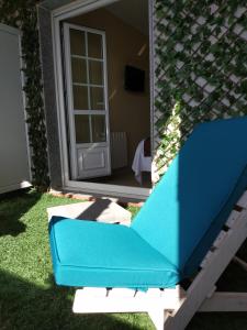 a blue couch in front of a house at Hostal Stella Del Mare in Camariñas
