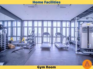 a gym with several tread machines in a room with windows at Aurora Place Suites Kuala Lumpur Bukit Jalil by Rasa Sayang in Kuala Lumpur