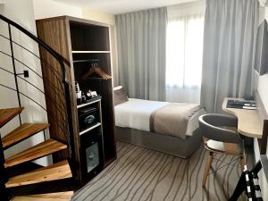 Postel nebo postele na pokoji v ubytování Quality Hotel Toulouse Centre