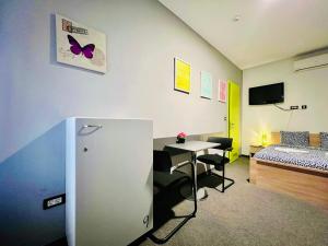 a room with a room with a bed and a table at Himalayan Hostel in Zagreb