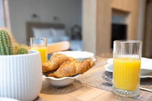 a table with a plate of food and a glass of orange juice at Helena Holiday A in St. St. Constantine and Helena