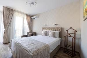 a bedroom with a large bed and a window at Helena Holiday A in St. St. Constantine and Helena +11 photos