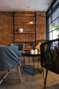 a room with a table and chairs and a brick wall at HOTEL CONCEPT BARILOCHE in San Carlos de Bariloche