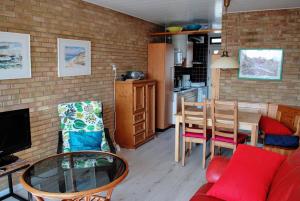 a living room with a table and a kitchen at Appartement Walvis nr. 16B in Vrouwenpolder