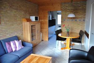 a living room with a couch and a table at Appartement Walvis nr. 20 in Vrouwenpolder