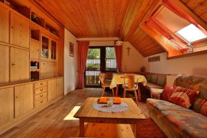a living room with a couch and a table at Mockenhof in Argenbühl