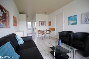a living room with a couch and a table at Appartement Walvis nr. 24 in Vrouwenpolder
