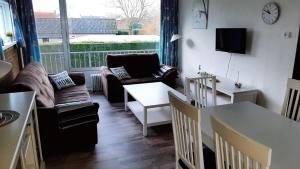 a living room with a couch and a table at Appartement Walvis nr. 26B in Vrouwenpolder