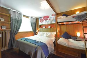 a bedroom with two bunk beds and a window at Cervino Valley House Rododendro in Breuil-Cervinia