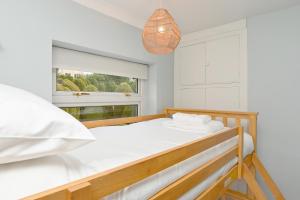 a bedroom with a bed and a window at Derwent Valley View in Whatstandwell
