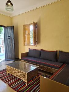 a living room with a couch and a coffee table at Villa Louiza in Mezraya