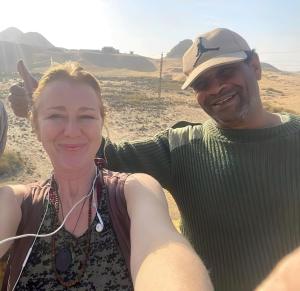 a man and a woman standing in the desert at Eye of horus in Cairo