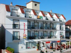 a large white building with windows and balconies at Hotel Bonaire in Revolta