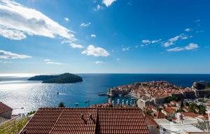 a view of a city and the ocean with a town at Guesthouse Home Sweet Home in Dubrovnik
