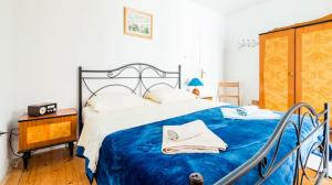 une chambre avec un lit avec une couverture bleue dans l'établissement Guesthouse Home Sweet Home, à Dubrovnik