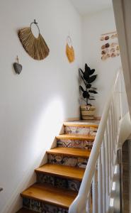 a staircase in a home with wooden steps and a potted plant at Hacienda Hotel in Friedrichshafen