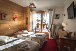 Postel nebo postele na pokoji v ubytování L'Alpage