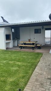 a picnic table in the back of a building at 5 bedroom home in Langebaan, located close to Club Mykanos and Laguna Mall in Langebaan