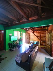 a living room with a couch and a flat screen tv at La Yeguada - Forest Point Cabin in El Quije