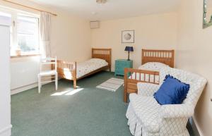 a living room with two beds and a couch at Spacious Swallow Cottage in Tisbury