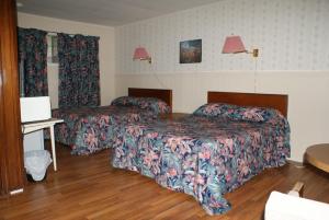 Postel nebo postele na pokoji v ubytování Regent Motel