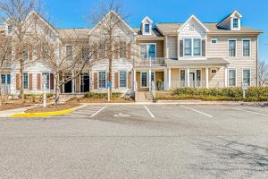 a large house with a parking lot in front of it at Bear Trap Dunes - 124G October Glory in Ocean View