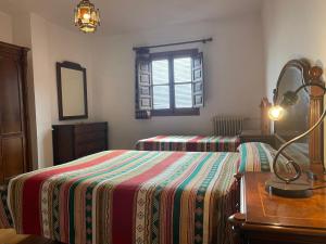 Postel nebo postele na pokoji v ubytování Hostal Rural Poqueira