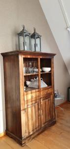 a wooden cabinet with a light on top of it at Sterrenhoeve in Castricum