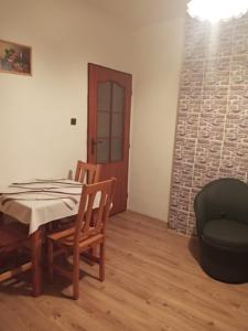a dining room with a table and a chair at Apartmány Božka in Terchová
