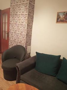 a living room with a couch and a chair at Apartmány Božka in Terchová